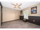 Cozy bedroom with grey floors, a ceiling fan and a sunny window at 146 Hidden Pointe Ln, Groveland, FL 34736