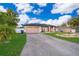 Charming single-story home with a two-car garage, inviting entrance, and well-kept landscaping at 146 Hidden Pointe Ln, Groveland, FL 34736