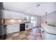 Well-lit kitchen with white cabinetry, stainless steel sink, and outside access at 146 Hidden Pointe Ln, Groveland, FL 34736