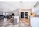 Modern kitchen open to living area, featuring white cabinets and black appliances at 146 Hidden Pointe Ln, Groveland, FL 34736