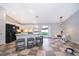 Bright kitchen with white cabinets, black appliances, and breakfast bar seating at 146 Hidden Pointe Ln, Groveland, FL 34736