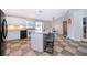 Open kitchen with white cabinets, breakfast bar, and view into dining area at 146 Hidden Pointe Ln, Groveland, FL 34736