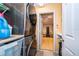 Laundry room with large washer and dryer machines and open doorway to the basement at 146 Hidden Pointe Ln, Groveland, FL 34736