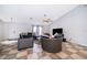 Bright living room with comfortable seating, ceiling fan, and large television at 146 Hidden Pointe Ln, Groveland, FL 34736