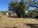 Extensive backyard presenting a large expanse of greenery, shade trees, and a concrete patio area at 1500 43Rd St, Orlando, FL 32839