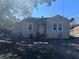 Charming bungalow-style home featuring a partially fenced yard, mature trees, and a covered parking area at 1500 43Rd St, Orlando, FL 32839