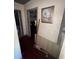 Hallway exhibiting hardwood floors, and an adjacent wall adorned with a framed picture at 1500 43Rd St, Orlando, FL 32839