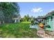 Expansive backyard with lush lawn, mature trees, and a storage shed, perfect for outdoor activities at 1588 Alloway Dr, Deltona, FL 32738