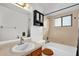 Bright bathroom features a shower-tub combination and a sink with a wooden vanity at 1588 Alloway Dr, Deltona, FL 32738