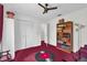 Bright bedroom with ceiling fan, closet, vinyl record rug and built in storage at 1588 Alloway Dr, Deltona, FL 32738