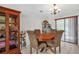 Cozy dining area featuring a wood table, upholstered chairs, and natural lighting at 1588 Alloway Dr, Deltona, FL 32738