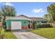 Charming single-story home with attached garage, colorful exterior paint, and well-maintained lawn at 1588 Alloway Dr, Deltona, FL 32738