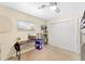 This carpeted bedroom is complete with a desk, ceiling fan, and closet at 2020 Geronimo Trl, Maitland, FL 32751