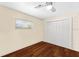 This empty bedroom has hardwood floors, a ceiling fan, and a closet at 2020 Geronimo Trl, Maitland, FL 32751
