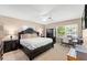 Bright bedroom with a ceiling fan, a large window, and a comfortable bed at 2020 Geronimo Trl, Maitland, FL 32751