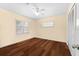 An empty bedroom with hardwood floors, ceiling fan, and closet at 2020 Geronimo Trl, Maitland, FL 32751