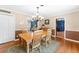 Warm dining area with classic wooden furniture, a view to the living room, and wood flooring at 2020 Geronimo Trl, Maitland, FL 32751