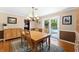Cozy dining room with chandelier, wood table and chairs, and a view to a swimming pool at 2020 Geronimo Trl, Maitland, FL 32751