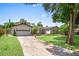 Inviting single-story home featuring a lovely front lawn, mature trees, and an expansive driveway at 2020 Geronimo Trl, Maitland, FL 32751