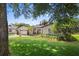 Well-kept single-story home featuring a lush front lawn, mature trees, and manicured landscaping at 2020 Geronimo Trl, Maitland, FL 32751