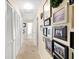 Well-lit hallway featuring many framed pictures and closet space at 2020 Geronimo Trl, Maitland, FL 32751