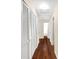 Hallway with hardwood floors and many storage closets at 2020 Geronimo Trl, Maitland, FL 32751