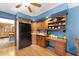 Charming kitchen featuring wooden cabinets, a black refrigerator, and an adjacent dining area at 2020 Geronimo Trl, Maitland, FL 32751