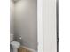 Powder room featuring a toilet, partial view of walls, and a door frame at 2171 Timber Creek Ln, Clermont, FL 34715