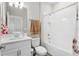 Fresh bathroom featuring a white vanity, tub and shower combo with white tile, and a stylish towel rack at 2171 Timber Creek Ln, Clermont, FL 34715