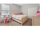 Bright bedroom with a white bed, cheerful decor, window with blinds, and a closet with sliding doors at 2171 Timber Creek Ln, Clermont, FL 34715