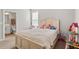 Bright bedroom with a white bed, cheerful decor, and ensuite bathroom featuring a neutral color palette at 2171 Timber Creek Ln, Clermont, FL 34715