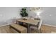 Bright dining room with wood-look floors, a large table, bench seating and attractive decor at 2171 Timber Creek Ln, Clermont, FL 34715