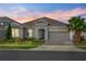 Charming single-story home boasts a lush lawn, landscaped beds, and a two-car garage with brick-paved driveway at 2171 Timber Creek Ln, Clermont, FL 34715