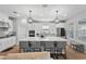 Modern kitchen featuring a large island with seating, stainless steel appliances and stylish pendant lighting at 2171 Timber Creek Ln, Clermont, FL 34715