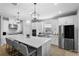 Modern kitchen featuring a large island with seating, stainless steel appliances, and stylish pendant lighting at 2171 Timber Creek Ln, Clermont, FL 34715