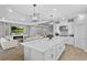 Stylish kitchen featuring quartz countertops, pendant lighting, stainless appliances, and an open layout to living areas at 2171 Timber Creek Ln, Clermont, FL 34715