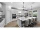 Bright kitchen with stainless steel appliances, an island with seating, and elegant countertops at 2171 Timber Creek Ln, Clermont, FL 34715