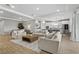 Spacious living area seamlessly connects to dining and kitchen, featuring modern decor and ample seating at 2171 Timber Creek Ln, Clermont, FL 34715