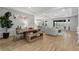Open-concept living space with seamless transition to dining, featuring neutral decor, and natural light at 2171 Timber Creek Ln, Clermont, FL 34715