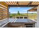 Outdoor kitchen area with a built-in grill, bar seating, and scenic views at 2171 Timber Creek Ln, Clermont, FL 34715