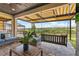 Inviting covered patio with comfortable seating, a swing, and views of the surrounding landscape at 2171 Timber Creek Ln, Clermont, FL 34715