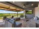 Covered outdoor living space with comfortable seating, ceiling fan, and a TV at 2171 Timber Creek Ln, Clermont, FL 34715