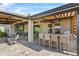 Spacious outdoor living area with a kitchen, seating, and beautiful views at 2171 Timber Creek Ln, Clermont, FL 34715