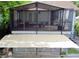 This charming back porch offers ample shade, comfortable furnishings, and a relaxing atmosphere for enjoying the outdoors at 238 Lake Dr, Orlando, FL 32835