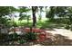 Serene backyard with lush greenery, a comfortable bench, and glimpses of the lake at 238 Lake Dr, Orlando, FL 32835