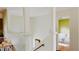 Bright hallway featuring white pillars and railing, leading to a living room with stylish decor at 238 Lake Dr, Orlando, FL 32835