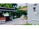 Outdoor patio with stone flooring, sun shade, and view of the landscaped backyard and lake at 238 Lake Dr, Orlando, FL 32835