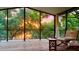 Inviting screened porch at sunset, offering a peaceful retreat with comfortable seating and scenic views at 238 Lake Dr, Orlando, FL 32835