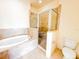 Bright bathroom offers a glass enclosed shower, and low-flow toilet at 2520 Bella Vista Dr, Davenport, FL 33897