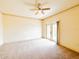 Spacious bedroom with ceiling fan, carpeted floor and French doors leading to balcony at 2520 Bella Vista Dr, Davenport, FL 33897